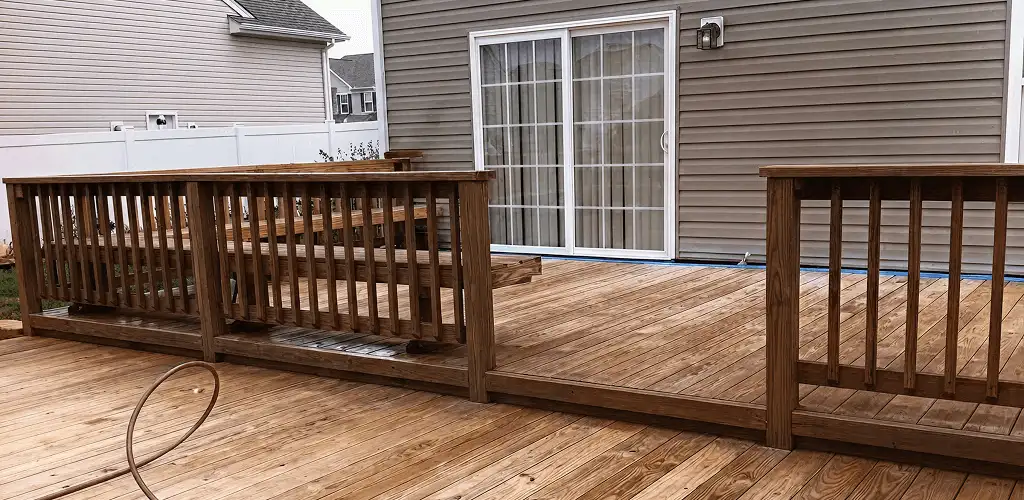 Deck sealing service protecting a backyard wood deck and railings in Providence, RI