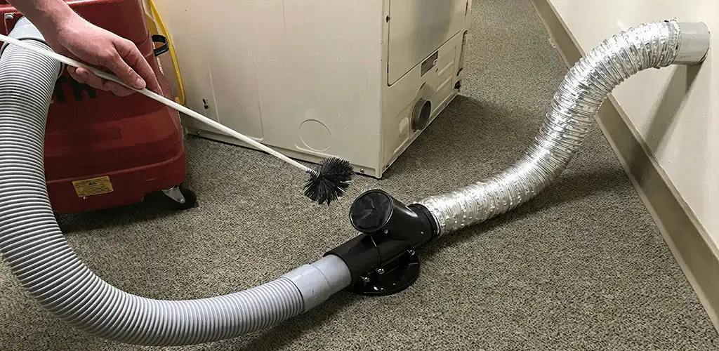 Dryer vent cleaning service removing lint from a dryer duct connection in Providence, RI