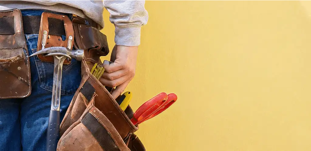 Handyman with tool belt ready for home repairs and maintenance in Providence, RI