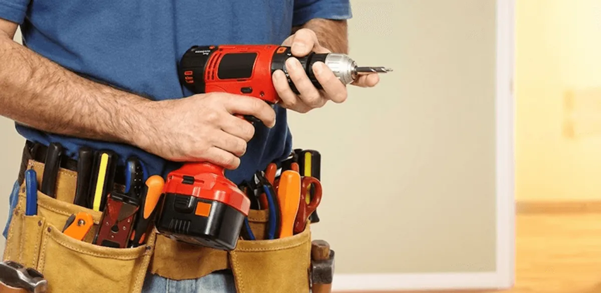 Handyman holding a power drill for home repairs and installations in Providence, RI
