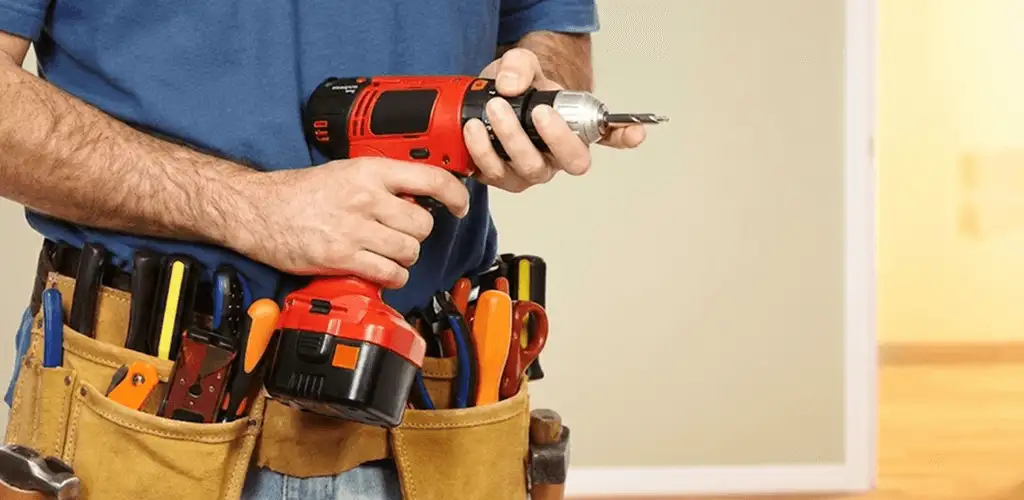 Handyman holding a power drill for home repairs and installations in Providence, RI
