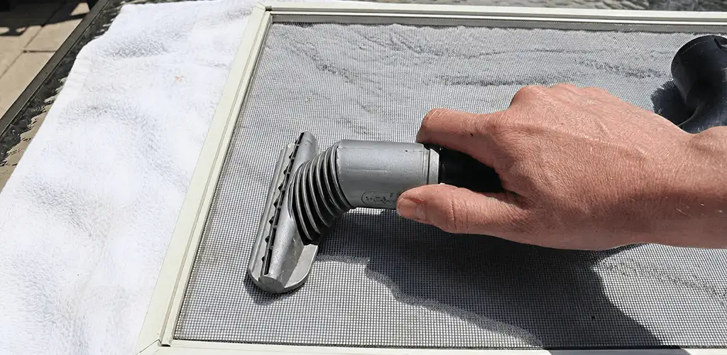 Window screen repair cleaning and fixing a damaged screen mesh in Providence, RI